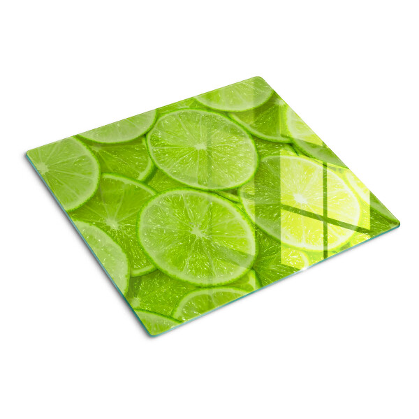 Steklena podloga za rezanje Rezine limete na zelenem ozadju