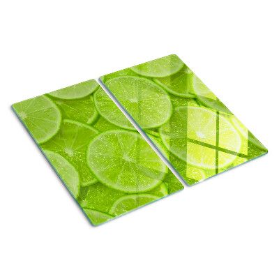 Steklena podloga za rezanje Rezine limete na zelenem ozadju