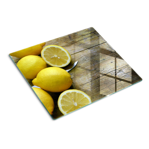 Steklena podloga za rezanje Limone na lesenem ozadju