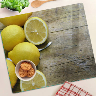 Steklena podloga za rezanje Limone na lesenem ozadju