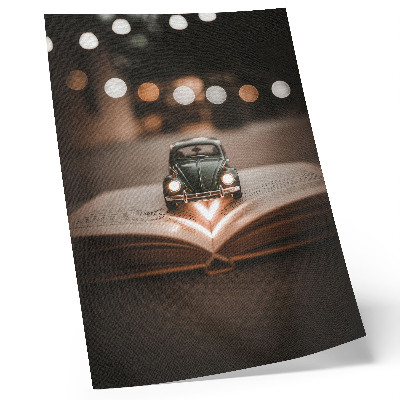 Premium stenski plakat Miniaturni avtomobilček na knjigi s čarobnimi lučkami