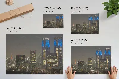 Plakat na platnu osvetljeno nočno mesto z modernimi nebotičniki