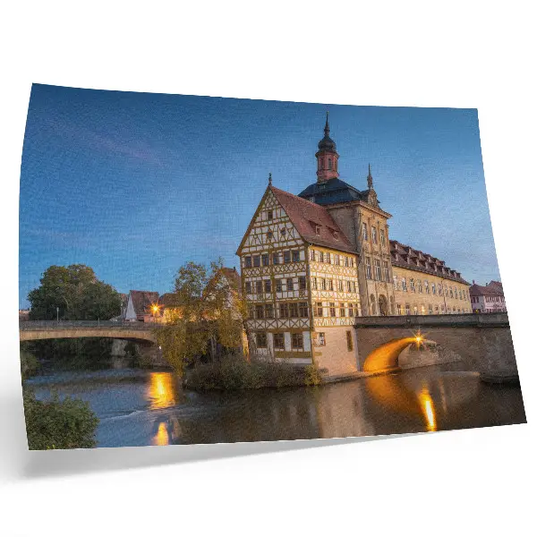 Plakat na platnu zgodovinska stavba z mostom nad vodo pod modrim nebom