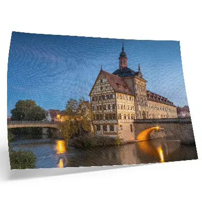 Plakat na platnu zgodovinska stavba z mostom nad vodo pod modrim nebom