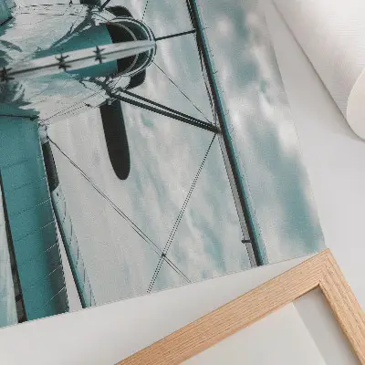 Plakat s teksturo platna pogled od spredaj na dvokrilno letalo v slogu industrijske elegance